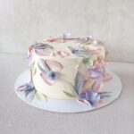 A cake with soft color petals. Please note the flavor profile of your choice at checkout: classic vanilla or dark chocolate. The cake has dimensions of 6 inches in diameter and 3-4 inches in height