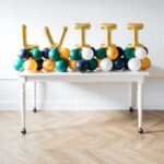 This arrangement includes six foil letter balloons (not helium) and latex balloons. The balloon color theme and letters can be customized to your preference. Foil letters are available in gold, silver, and rose gold, and they are 16” in size.