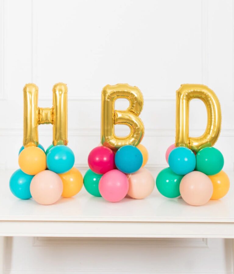 This arrangement features three letter balloons (not helium) and latex balloons. The balloon color theme and numbers can be customized to your preference. Foil letters are available in Gold, Silver, and Rose Gold, and they are 16” in size.