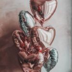 Seven heart shaped foil balloons inflated with helium , color theme can be customized