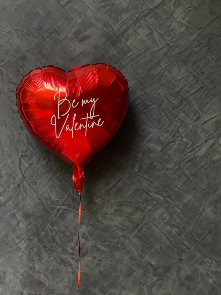 Red heart shaped helium balloons