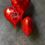 Red heart shaped helium balloons