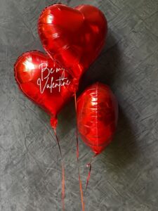 Red heart shaped helium balloons