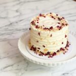 Enjoy a delightful 1. 2kg ribbon almond cake, adorned with toasted almonds and delicate rose petals—a perfect blend of flavor and elegance the cake has dimensions of 6 inches in diameter and 4-5 inches in height