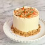 Indulge in a delicious 1. 3kg carrot cake, layered with rich cream cheese frosting and topped with a delightful crumble—a perfect treat for any occasion the cake has dimensions of 6 inches in diameter and 4-5 inches in height