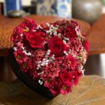 Give your loved one a beautiful heart-shaped arrangement featuring stunning red roses and vibrant red chrysanthemums