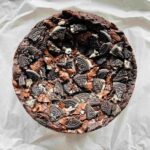 Fudge cake layered with melted chocolate and oreos, measuring 7 inches in diameter and 3-4 inches in height.