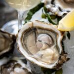 The signature oyster experience | 12 oysters with signature toppings · 2 glasses of sparkling